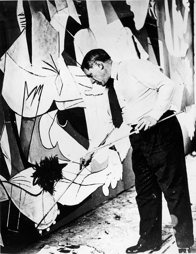 Pablo Picasso painting Guernica in his studio, Paris, 1937; photograph by Dora Maar